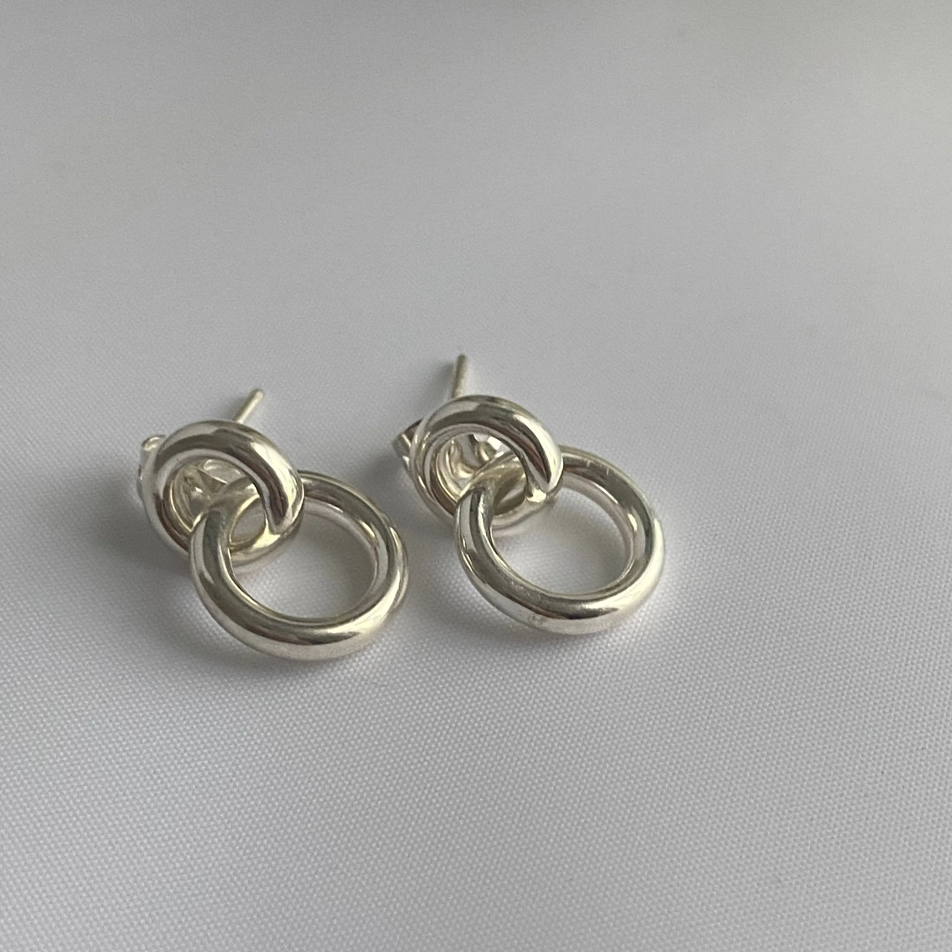 Two Small Interlinked Hoop Sterling Silver Stud Earrings